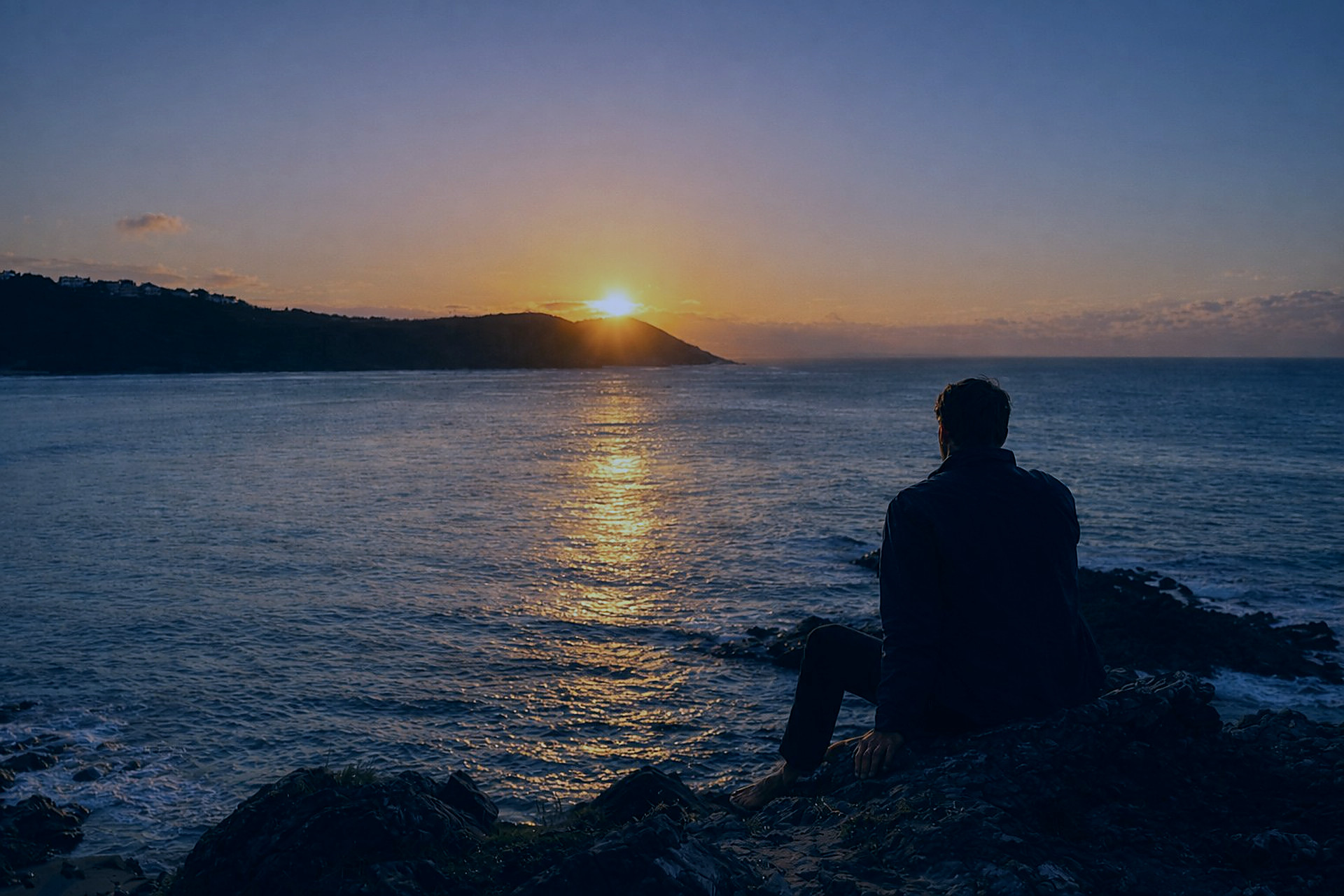 The rules have changed — a figure contemplating the horizon at sunset